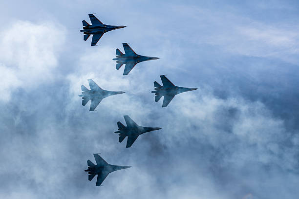 Silhouettes of russian fighter aircrafts SU-27 in the sky Silhouettes of russian fighter aircrafts SU-27 in the sky air force stock pictures, royalty-free photos & images