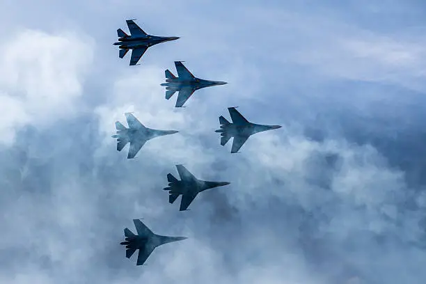Photo of Silhouettes of russian fighter aircrafts SU-27 in the sky