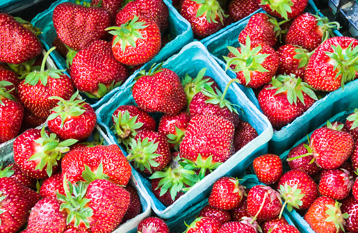 Baskets of juicy , ripe strawberries at a Cape Cod farmers market.