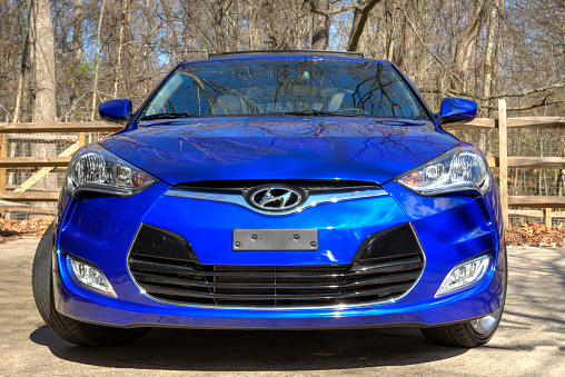 Charlotte, NC, US - February 27, 2013: First Generation Blue colored Hyundai Veloster parked near the woods.