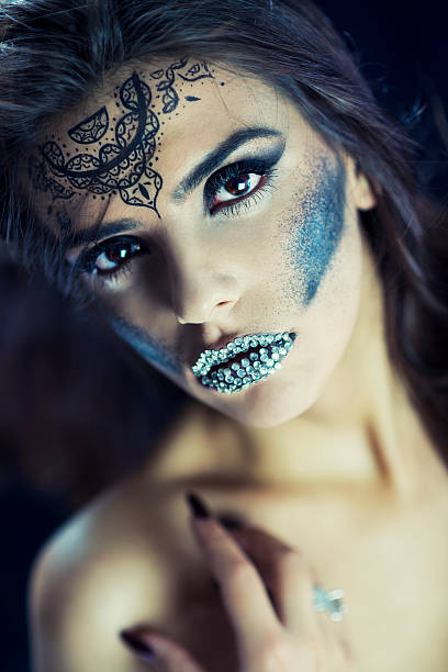 istock Beautiful Woman with Face Paint Art and Diamond Lips 496888298