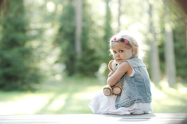 istock Girl playing with teddy bear 496913806