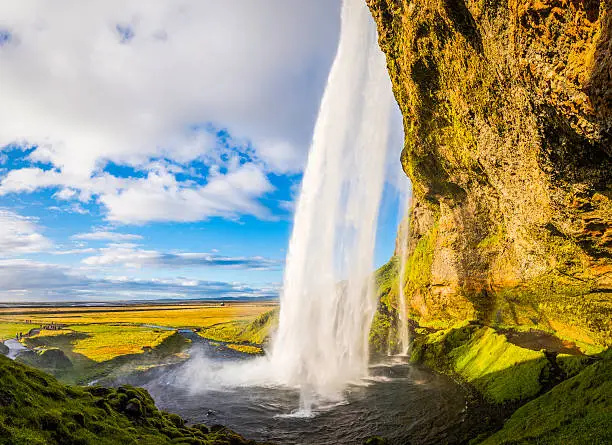 The iconic waterfall of Seljalandsfoss tumbling from the mountain cliffs of southern Iceland into the clear pool below. ProPhoto RGB profile for maximum color fidelity and gamut.