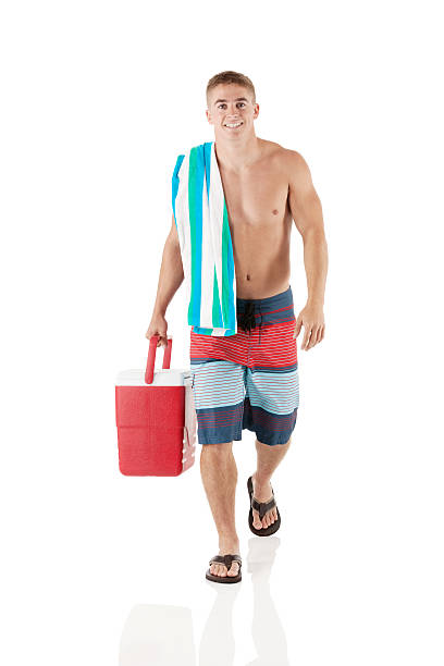 istock Shirtless man with towel holding cooler 496916373