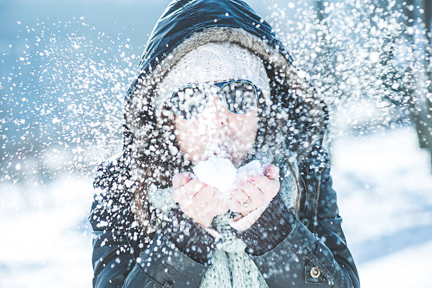 istock Young woman blowing snow outdoor 496917242