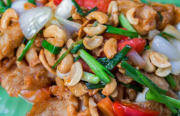 asia food fried meat with onion, cashew nut and sweet pepper