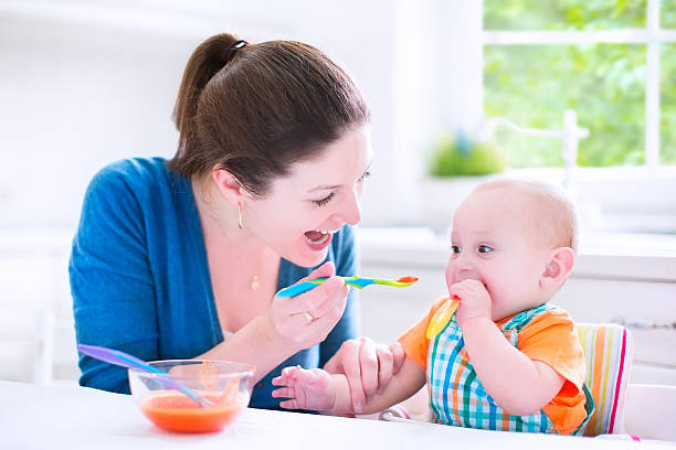 istock Baby boy eating his first solid food 496919611