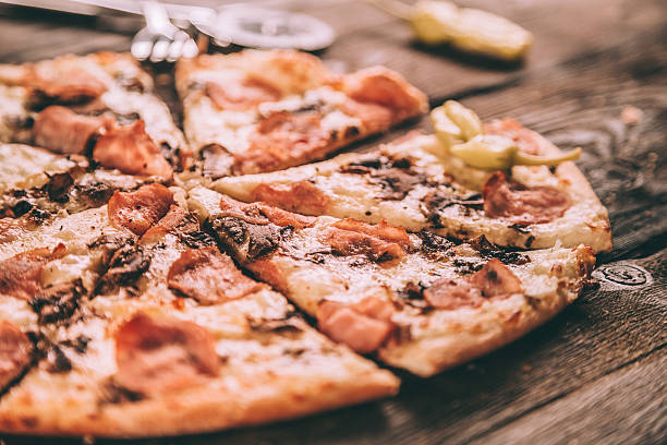 istock Homemade Pizza Slices with ham and mushrooms 496919734