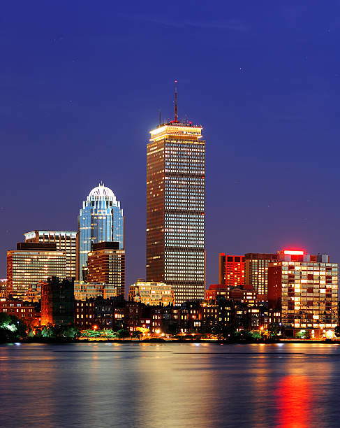 Boston city skyline at dusk Boston city skyline at dusk with Prudential Tower and urban skyscrapers over Charles River with lights and reflections. prudential tower stock pictures, royalty-free photos & images