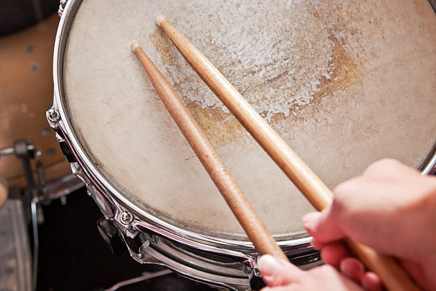 Snare Drum A very worn snare drum and drum sticks. drummer hands stock pictures, royalty-free photos & images