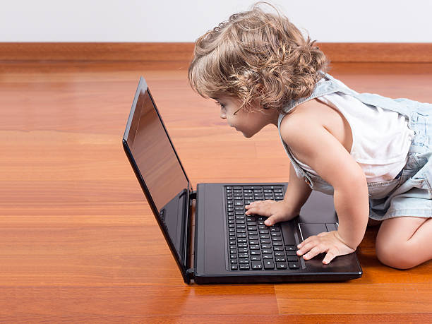 istock Concentrate baby looking at screen of  laptop computer 496920022