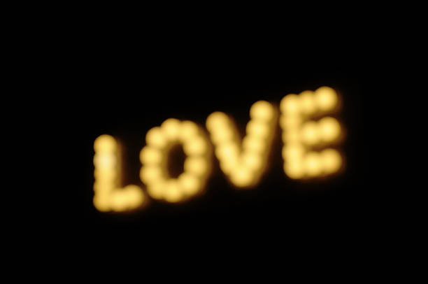 Defocused of light for Love word blur in black background