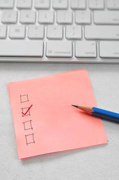 checklist Sticky note with checklist on office desk with computer keyboard and pencil keyborad stock pictures, royalty-free photos & images