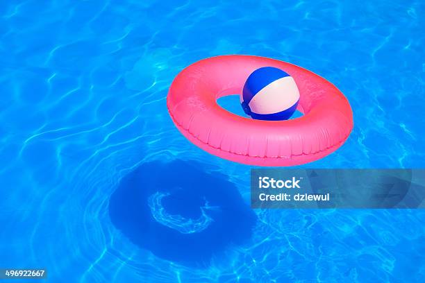 Colorful Inflatable Ball And Round Tube Floating In Swimming Poo Stock Photo - Download Image Now
