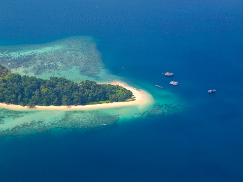 View from plane to Andaman Islands, an archipelago in the Bay of Bengal between India and Myanmar. There are a lot of people on beach.