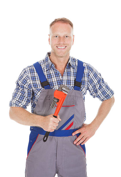 istock Smiling Handyman Holding Adjustable Wrench 496923522