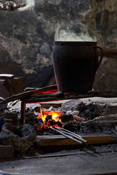 istock Cooking pot over a blacsmith's fireplace 496924045