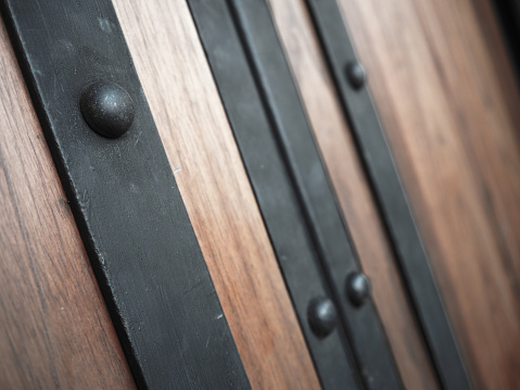traditional asian black door handle with pin and wooden door.
