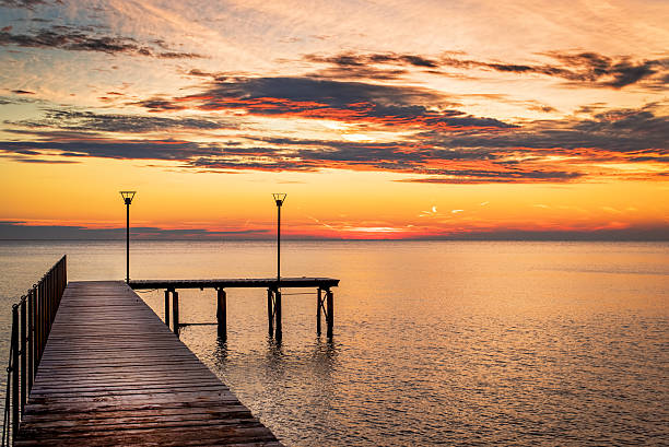 istock Wooded bridge in the port between sunrise. 496925972