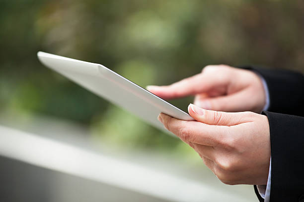 istock Businesswoman Using Digital Tablet Outdoors 496927428