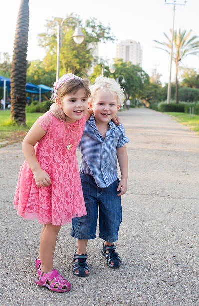istock Small embraced brother and sister in the park. 496927910