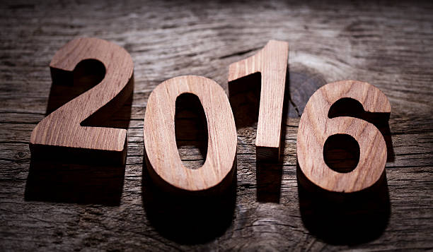 istock Happy New Year 2016 back lit wooden letters 496928632