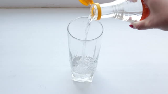 Vinegar and baking soda sparkling water glass on  white background