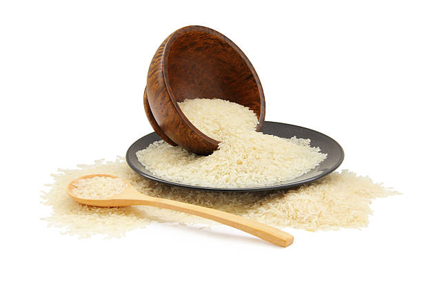 istock raw rice in spoon,bowl and plates 496941027