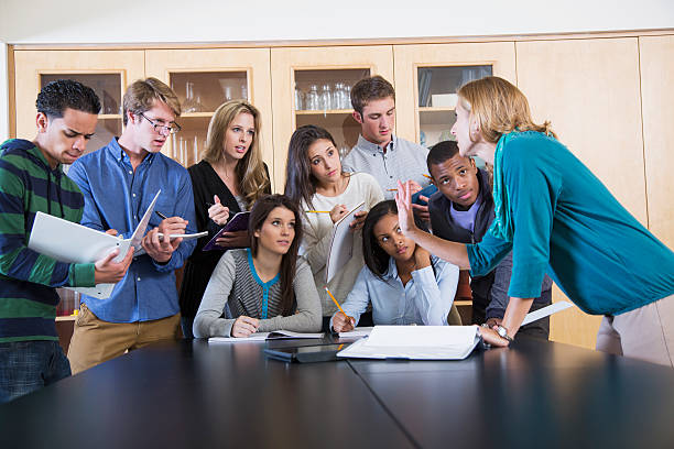 istock Science teacher with group of high school or college students 496941437