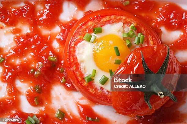Eggs Baked Inside Ripe Tomatoes And Sauce Top View Stock Photo - Download Image Now