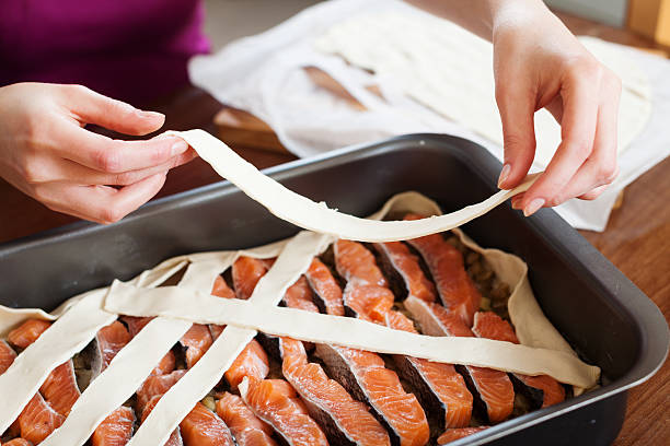 istock Close up of cooking fish pie with raw salmon 496943639
