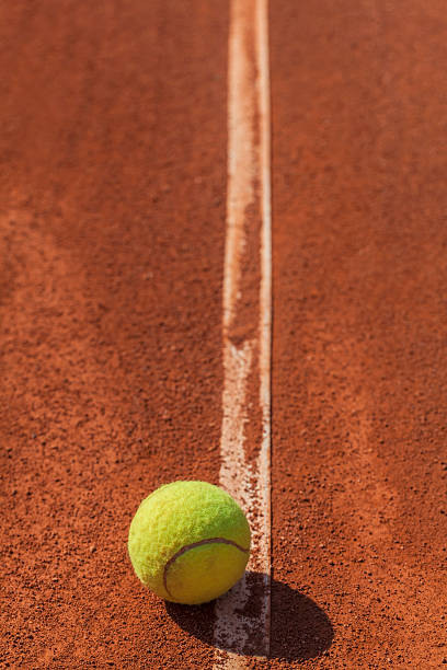 CLose-up photograph of tennis ball on the court