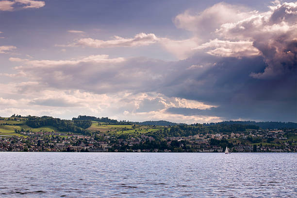 Setting sun over a city by the lake. stock photo