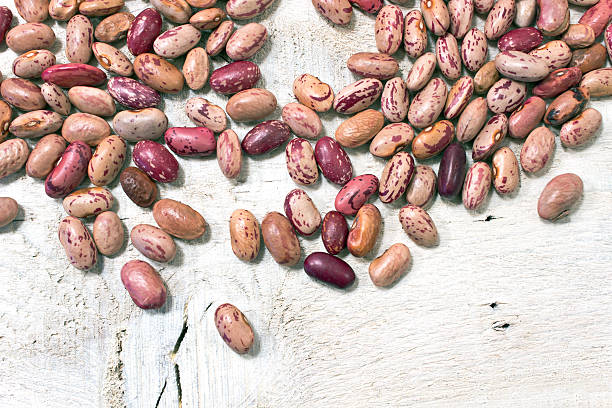 istock Cranberry beans on white wooden background 496947727