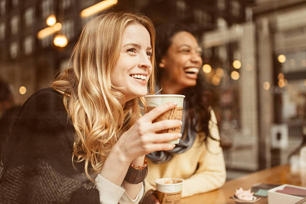 Sharing a laugh with my friend Girlfriends sharing a laugh in Coffeeshop coffee drink stock pictures, royalty-free photos & images