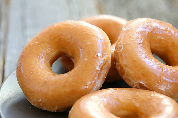 Glazed donuts Glazed donuts background image. Macro with shallow dof. donut stock pictures, royalty-free photos & images