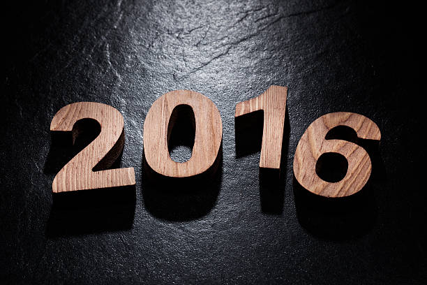 istock Happy New Year 2016 back lit wooden letters 496948940