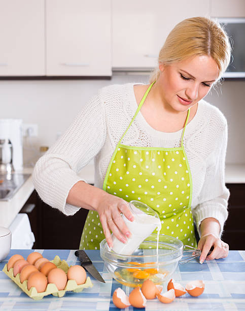istock woman making dough or omlet 496949874