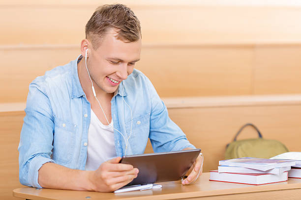istock Student at the desk with portable tablet 496949922