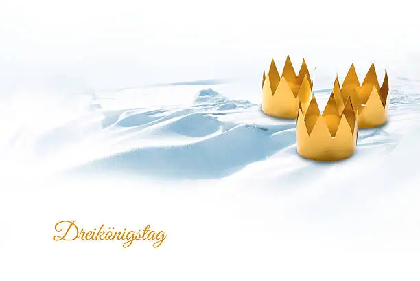 Epiphany, symbolized by three tinkered crowns on a snowy background, german text DreikÃ¶ningstag, that means Three King's Day