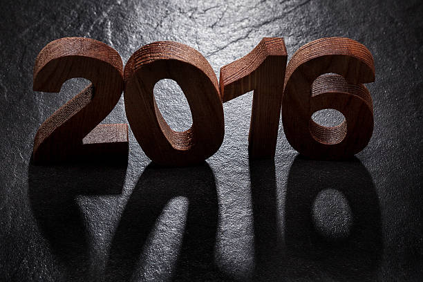 istock Happy New Year 2016 back lit wooden letters 496950308