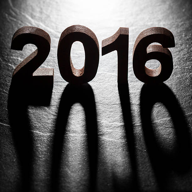 istock Happy New Year 2016 back lit wooden letters shadow 496950322