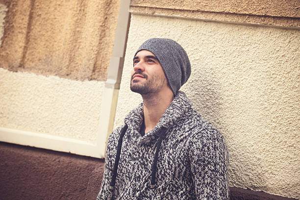 istock Handsome young man standing by the wall 496951590