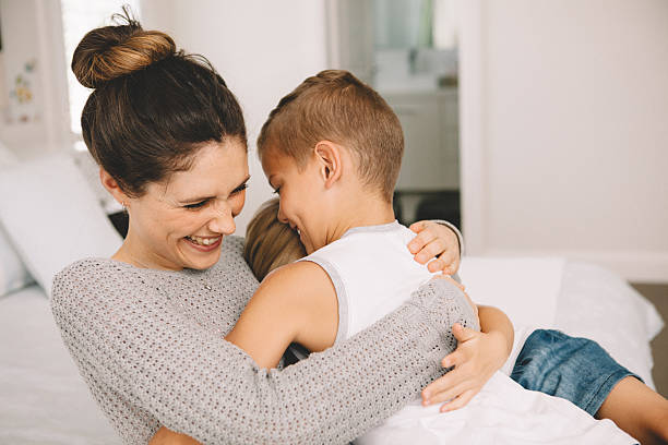 istock kids hug their mom 496951946