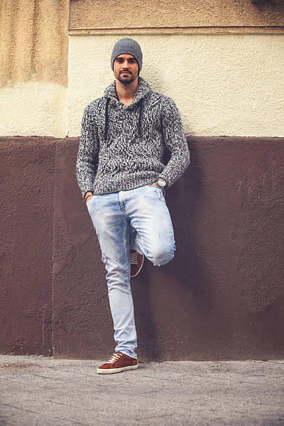 istock Handsome young man standing by the wall 496952102