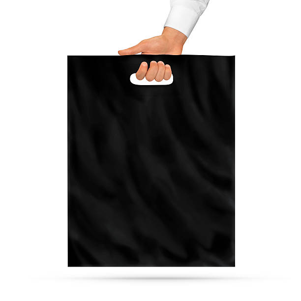 istock Blank black plastic bag mock up holding in hand. 496952288
