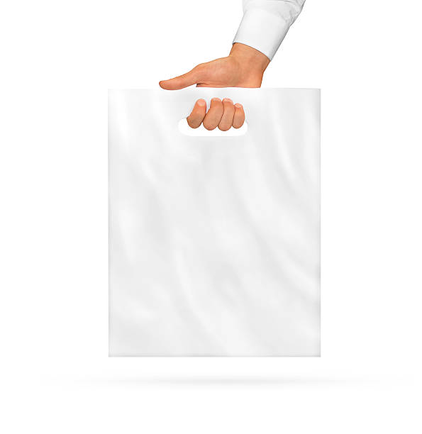 Small blank plastic bag mock up holding in hand. stock photo