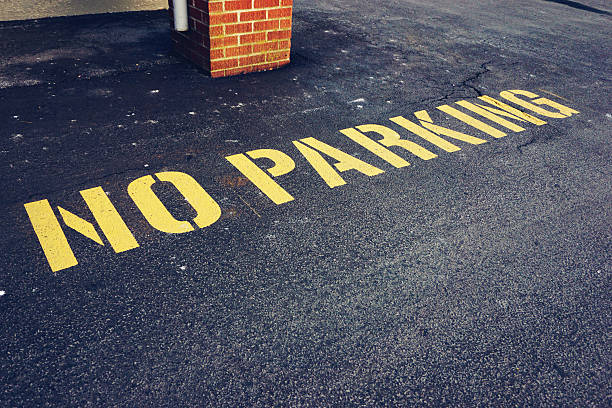 istock the words no parking painted on pavement 496953650