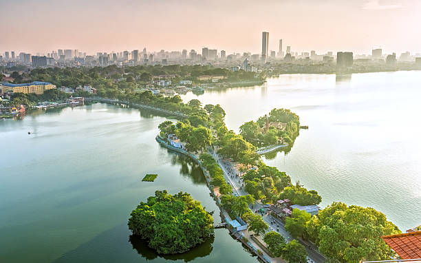The road crossing the island Westlake, Hanoi, Vietnam The road crossing the island Westlake, Hanoi, Vietnam with green tree-lined streets, temples located between small oasis in sunshine of West Lake and boasts a beautiful evening in capital of Vietnam west lake stock pictures, royalty-free photos & images
