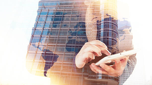 istock Multiple exposure businessman with tablet office building and world map 496959226